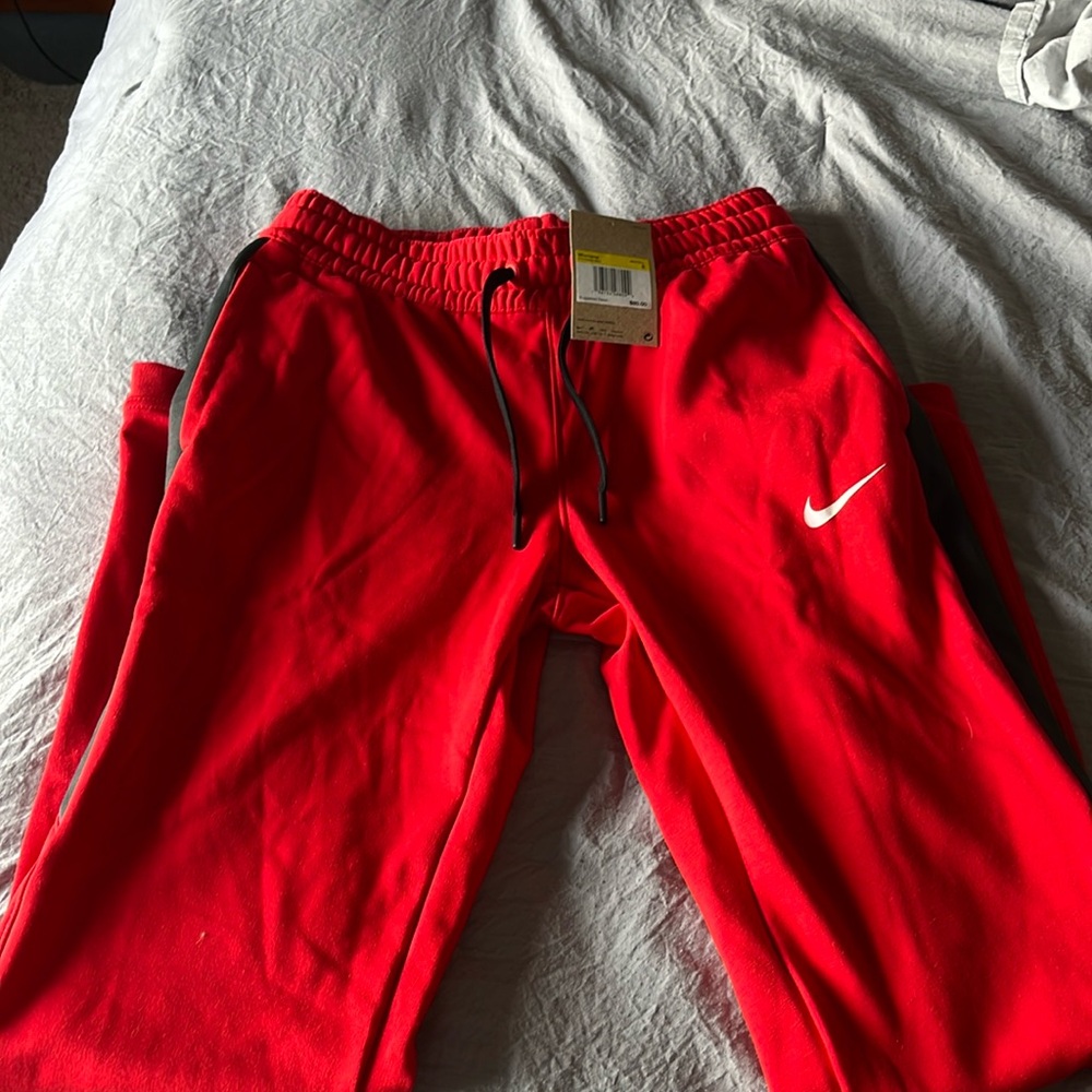 Brand new with tags! Red and black basketball pants. Size small.